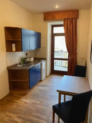 a kitchen with a sink and a table with a table at 1 Bed Flat - Sleeps 2 - Pets - Smoking on terrace in Prague