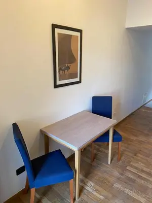 a dining room table and two blue chairs at 1 Bed Flat - Sleeps 2 - Pets - Smoking on terrace in Prague