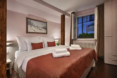 a bedroom with a large bed with towels on it at Boutique Residence by Little King in Prague
