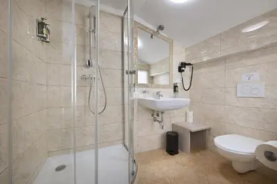 a bathroom with a shower and a sink and a toilet at Boutique Residence by Little King in Prague