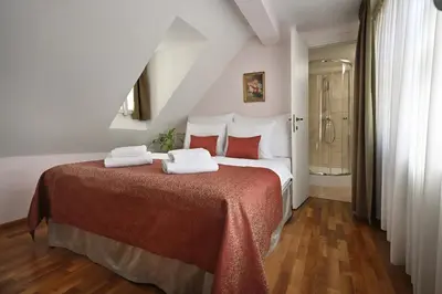 a bedroom with a large bed with towels on it at Boutique Residence by Little King in Prague