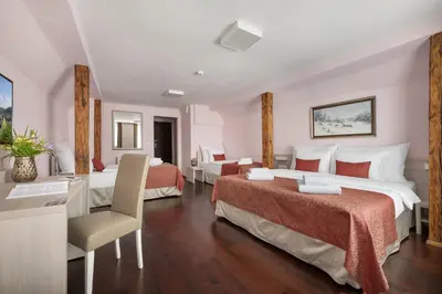 a hotel room with two beds and a desk at Boutique Residence by Little King in Prague