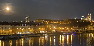 a city at night with a river and buildings at Spectacular Prague Views room for 1 or 2 in Prague