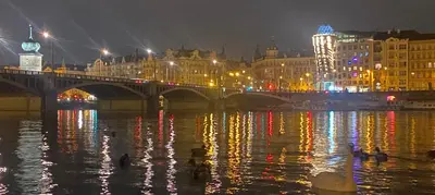 a bridge over a river with a city at night at Spectacular Prague Views room for 1 or 2 in Prague