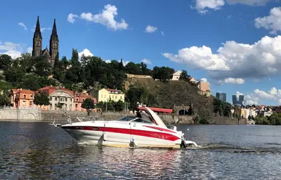 a red and white boat in the water near a city at Spectacular Prague Views room for 1 or 2 in Prague