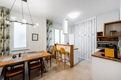 a kitchen and dining room with a table and chairs at Family Flat Bartolomejska in Prague