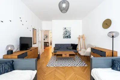 a living room with a couch and a tv at Family Flat Bartolomejska in Prague