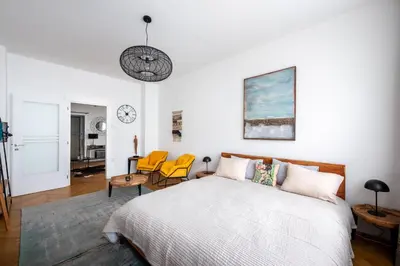a bedroom with a bed and chairs in it at Family Flat Bartolomejska in Prague