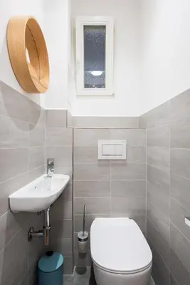 a bathroom with a toilet and a sink at Family Flat Bartolomejska in Prague