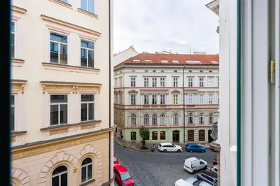 a view from a window of a parking lot with cars at Family Flat Bartolomejska in Prague