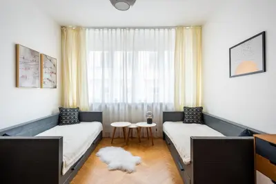 a room with two beds and a window at Family Flat Bartolomejska in Prague