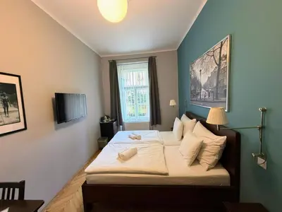 a bedroom with two beds and a window at Central Station Studios in Prague