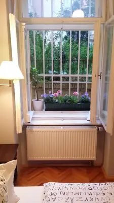 a bedroom with a large bed and a window at Central Station Studios in Prague