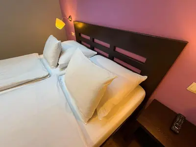 a bedroom with a bed and a table in it at Central Station Studios in Prague