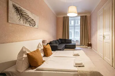 a living room with a bed and a couch at Rose Ruterra Suite in Prague