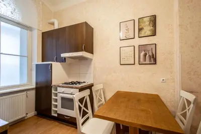 a small kitchen with a table and a stove at Rose Ruterra Suite in Prague
