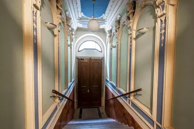 a hallway with a wooden door in a building at Rose Ruterra Suite in Prague