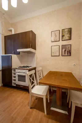 a kitchen with a wooden table and a dining room at Rose Ruterra Suite in Prague