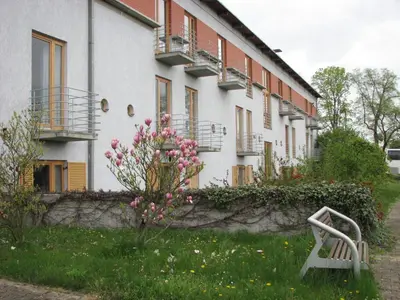a building with pink flowers in front of it at Centrum Mariapoli in Prague