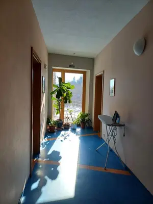 a room with a hallway with a table and a window at Centrum Mariapoli in Prague