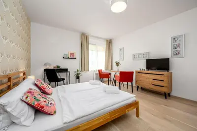 a bedroom with a bed and a table and chairs at Art Deco Suite in Prague