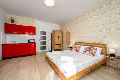 a bedroom with a large bed and red cabinets at Art Deco Suite in Prague
