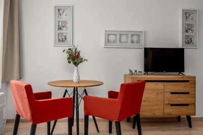 a room with a table and two chairs and a tv at Art Deco Suite in Prague