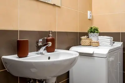 a bathroom with a sink and a toilet at Art Deco Suite in Prague