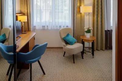 a room with a desk and a chair and a table at Hotel Silenzio in Prague