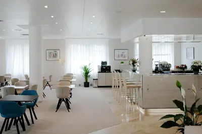 a room with chairs and a counter and a kitchen at Hotel Silenzio in Prague