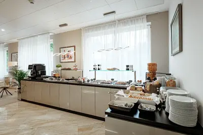 a kitchen with a counter top with plates and dishes at Hotel Silenzio in Prague