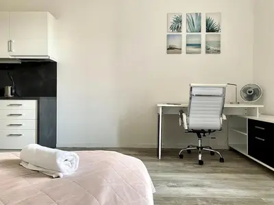 a bedroom with a desk and a bed and a chair at Parkside Studio in Vinohrady in Prague