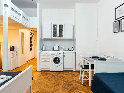 a kitchen with a washing machine in a white kitchen at ELSO center apartment in Prague