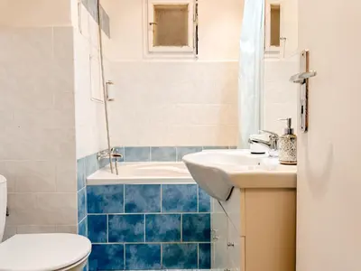 a bathroom with a toilet and a sink and a tub at ELSO center apartment in Prague