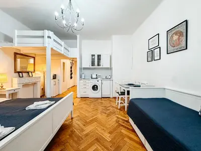 a large room with a bed and a kitchen at ELSO center apartment in Prague