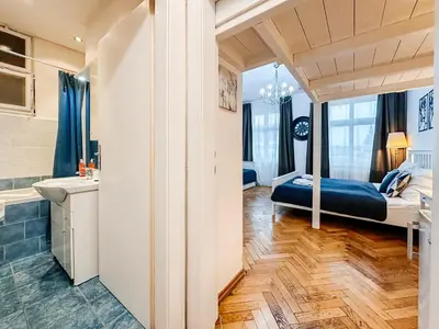 a bedroom with a bed and a bathroom at ELSO center apartment in Prague