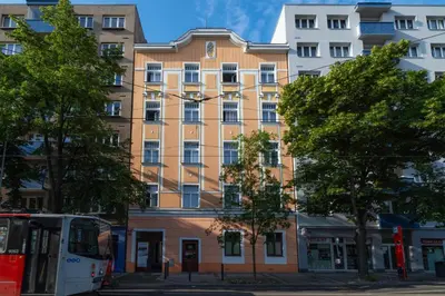a bus is parked in front of a building at Hotel Leon in Prague