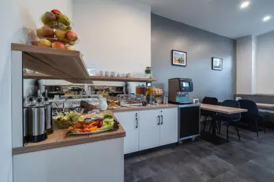 a kitchen with a counter with fruits and vegetables on it at Hotel Leon in Prague