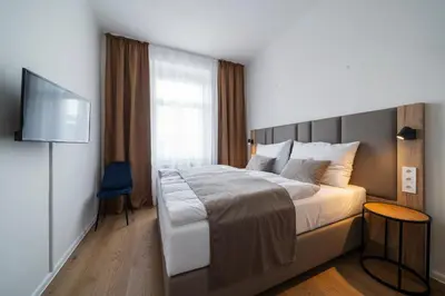 a hotel room with a bed and a television at Hotel Leon in Prague