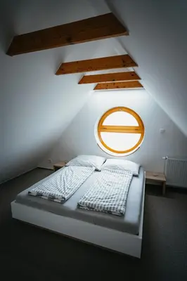 a bedroom with a bed in a attic at Penzion Tsport in Wotitz