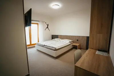 a bedroom with a bed and a television in it at Penzion Tsport in Wotitz