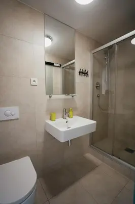a bathroom with a sink and a shower at Penzion Tsport in Wotitz
