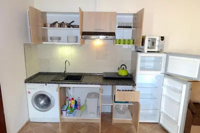 a small kitchen with a sink and a washing machine at Green Club in Tursko