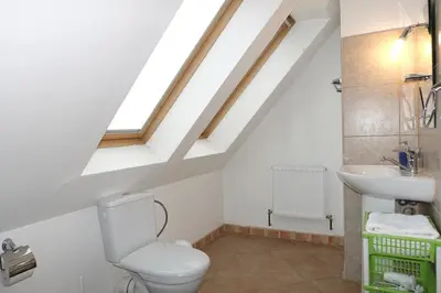 a bathroom with a toilet and a sink at Green Club in Tursko