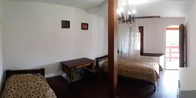 a bedroom with two beds and a table and a mirror at Green Club in Tursko