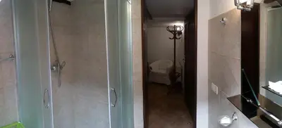 two views of a bathroom with a shower and a toilet at Green Club in Tursko