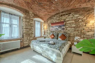 a bedroom with a brick wall and a bed in a room at Centre Prague Retreat Residence in Prague