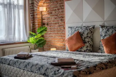 a bedroom with a bed with a brick wall at Centre Prague Retreat Residence in Prague