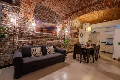 a living room with a brick wall and a couch and a table at Centre Prague Retreat Residence in Prague