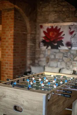 a large wooden game table with blue lights on it at Centre Prague Retreat Residence in Prague